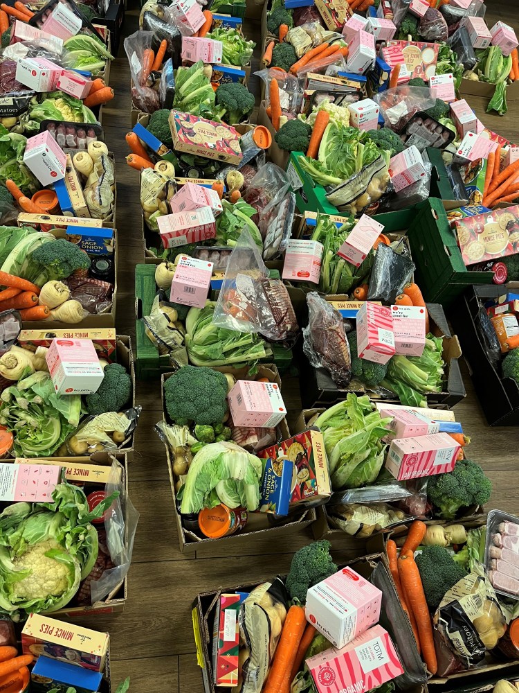 lots of boxes full of vegetables and Christmas goodies