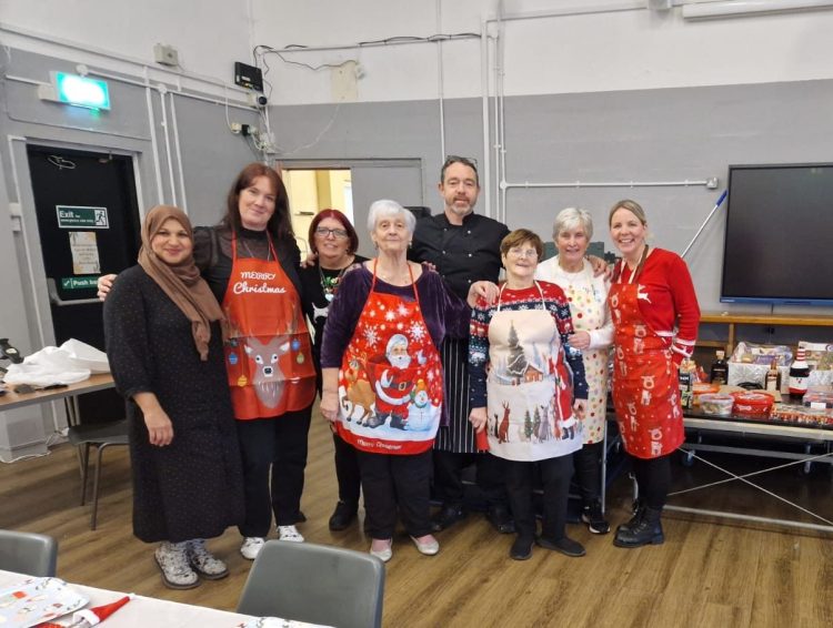 a group of smiling volunteers at the Christmas dinner