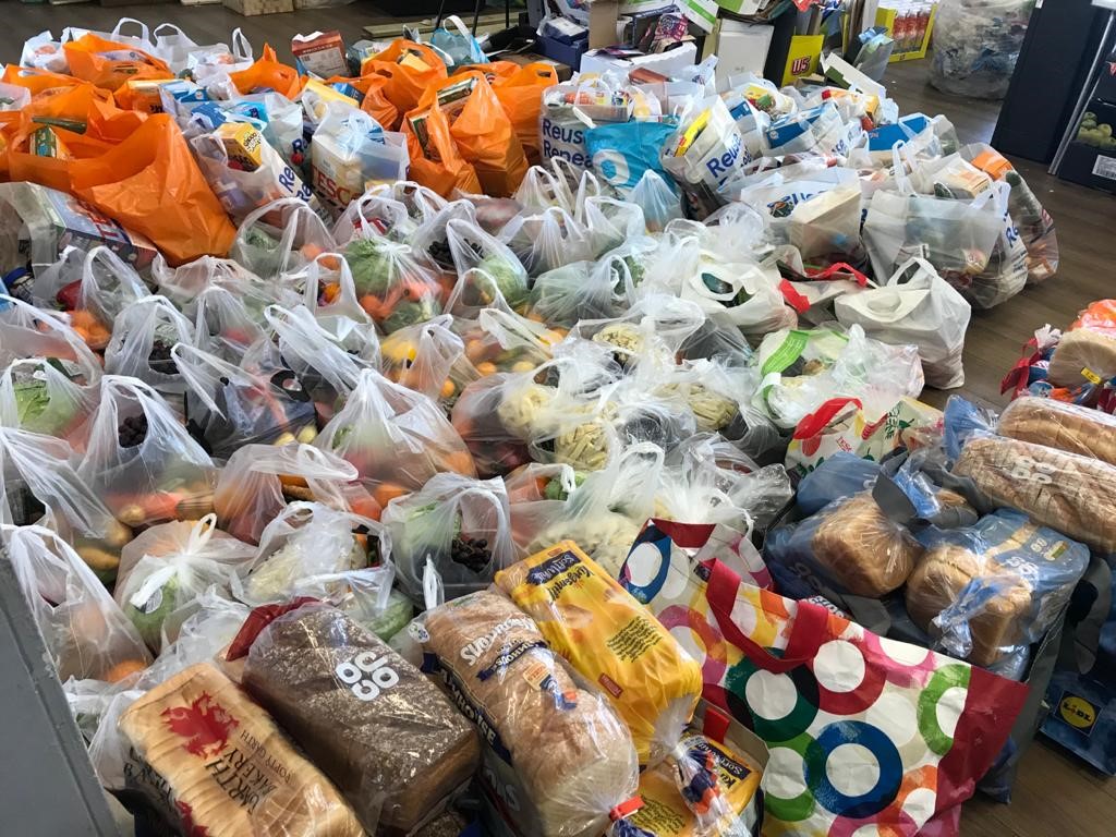 piles of carrier bags filled with essential groceries